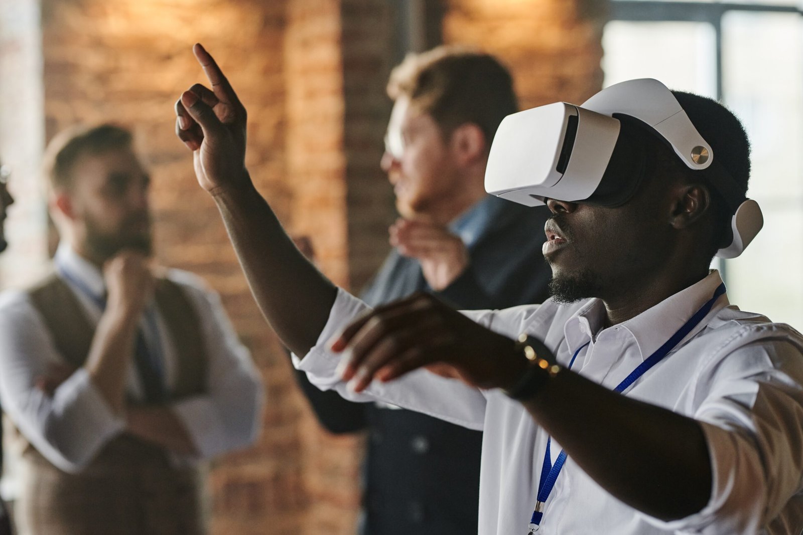 pexels-henri-mathieusaintlaurent-8355218 Man wearing virtual reality glasses in a room with people